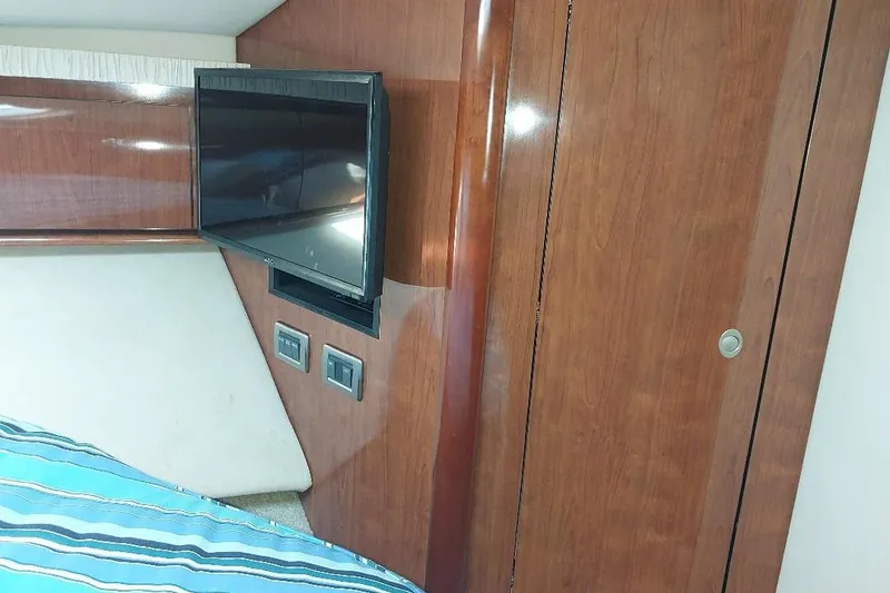 Slide: The Image of Interior of 2004 Sea Ray 420 Sundancer with TV and wooden paneling. - 21