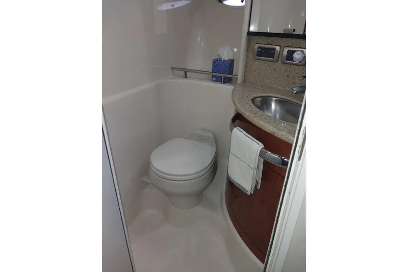 Slide: The Image of 2004 Sea Ray 420 Sundancer bathroom with toilet, sink, and countertop. - 22