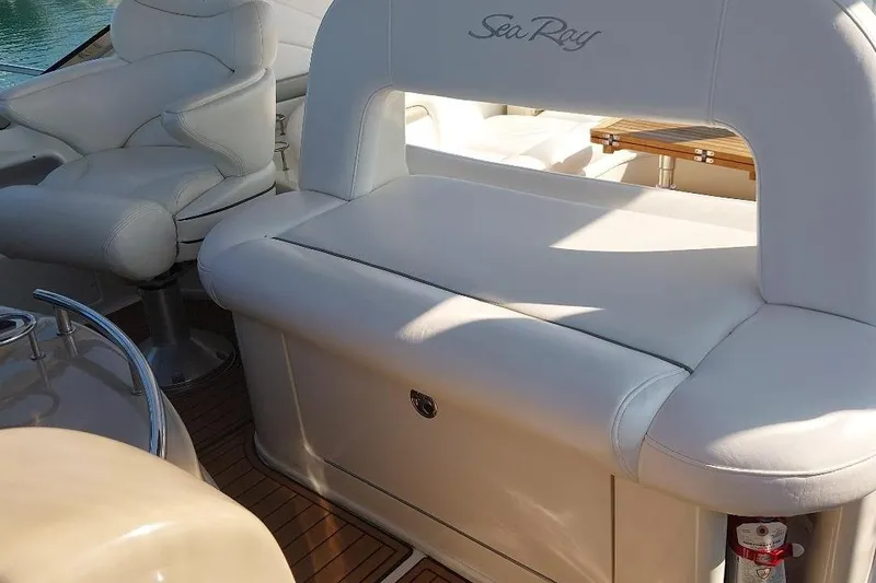 Slide: The Image of 2004 Sea Ray 420 Sundancer interior with white leather seating and wooden flooring. - 6