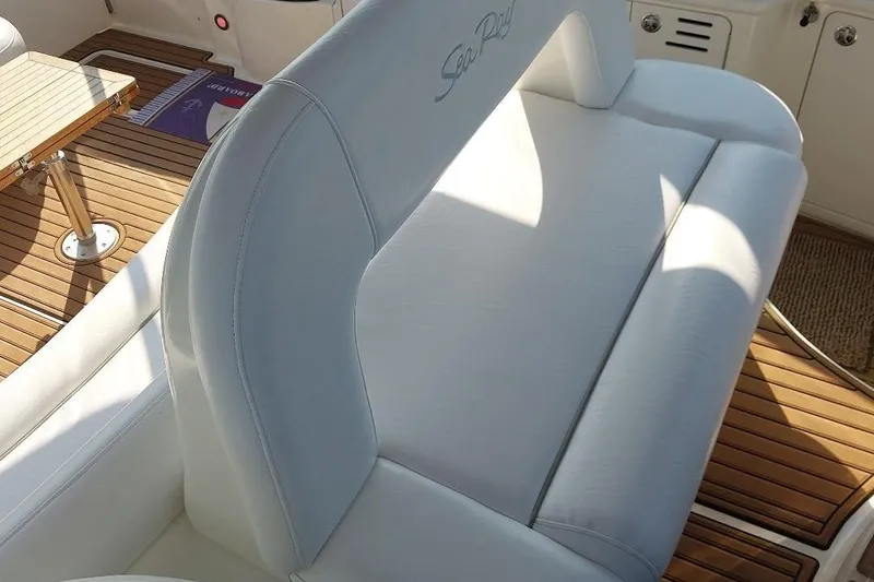 Slide: The Image of White leather seating on 2004 Sea Ray 420 Sundancer yacht with teak flooring. - 7