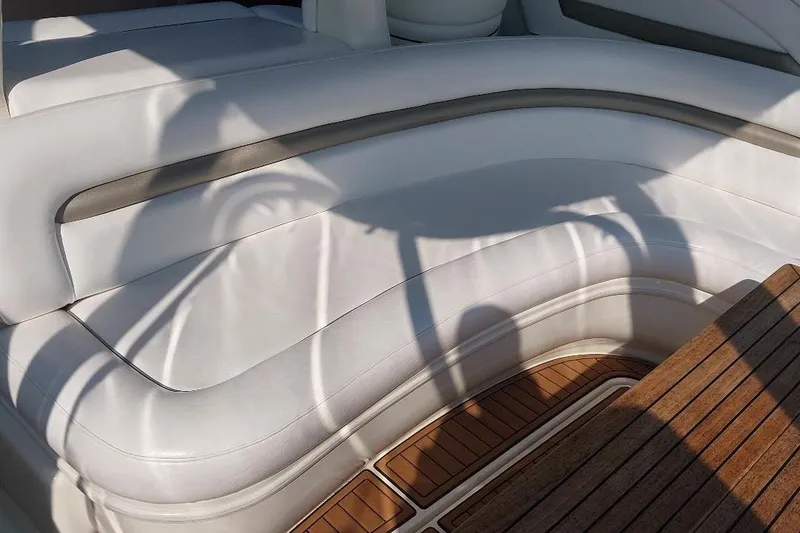 Slide: The Image of Luxurious white seating on 2004 Sea Ray 420 Sundancer yacht with wooden deck. - 8