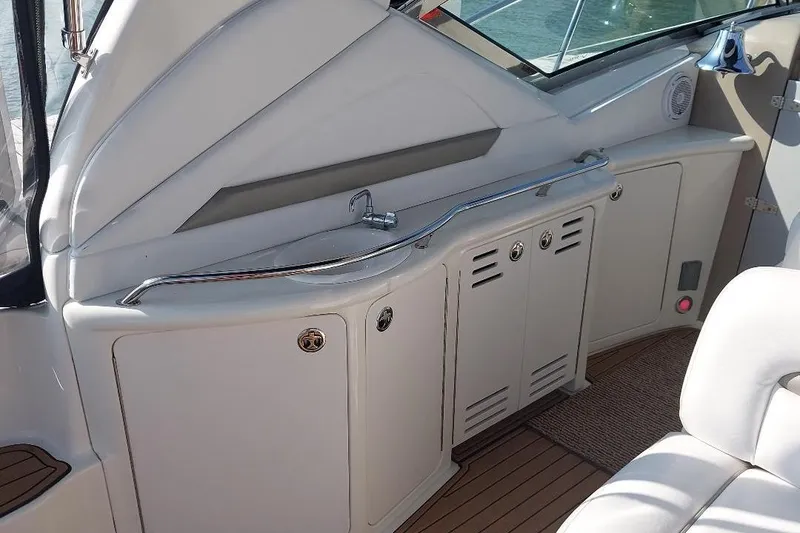 Slide: The Image of 2004 Sea Ray 420 Sundancer yacht interior with sink and storage cabinets. - 9