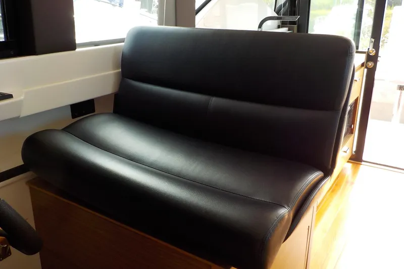 Slide: The Image of Control panel of 2018 Tiara Yachts 39 Coupe with steering wheel and joystick controls. - 18