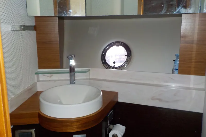 Slide: The Image of Interior cabin of 2018 Tiara Yachts 39 Coupe with white seating and wooden accents. - 28