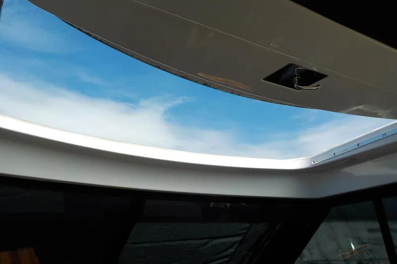 Slide: The Image of Shower area in 2018 Tiara Yachts 39 Coupe, featuring a wooden bench and chrome fixtures. - 32