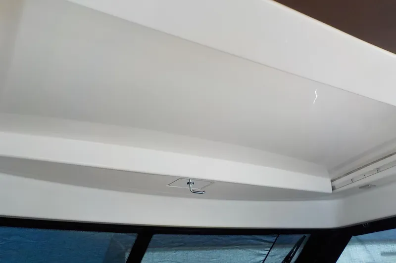 Slide: The Image of Shower area in 2018 Tiara Yachts 39 Coupe with wooden bench and handheld showerhead. - 33