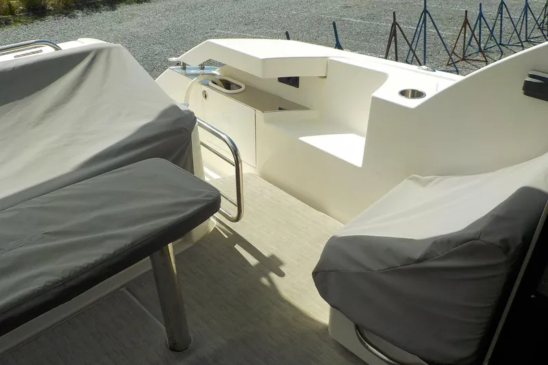 Slide: The Image of 2018 Tiara Yachts 39 Coupe interior with seating and table in cockpit area. - 41