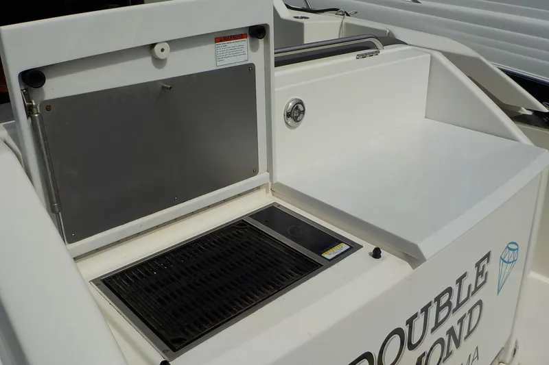 Slide: The Image of Outdoor grill area on a 2018 Tiara Yachts 39 Coupe boat. - 49
