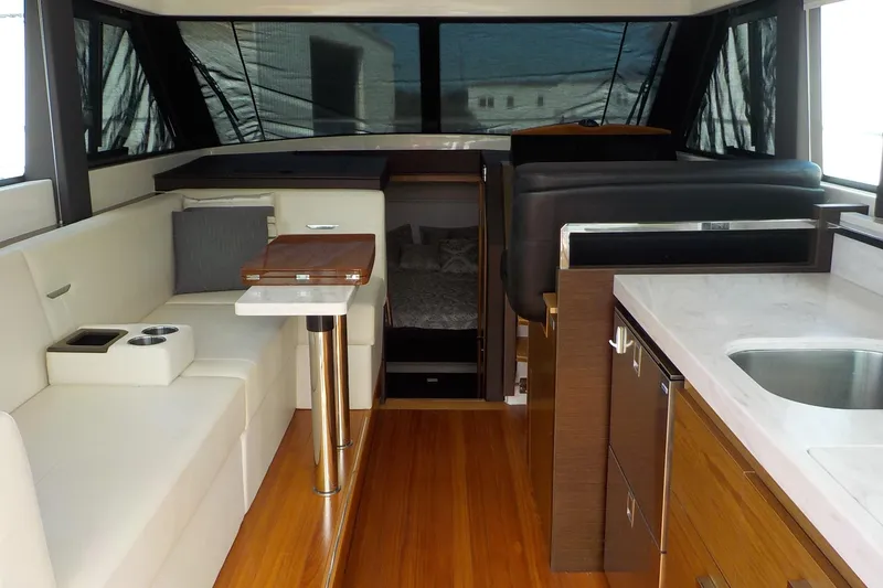 Slide: The Image of Interior of 2018 Tiara Yachts 39 Coupe with elegant seating and wooden table. - 5