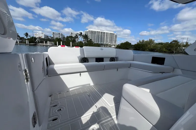 Slide: The Image of Luxurious interior of 2025 Cigarette 41 Nighthawk boat with white seating and scenic waterfront view. - 20