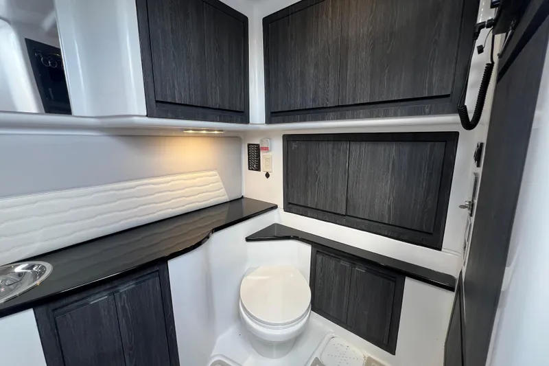 Slide: The Image of Luxurious 2025 Cigarette 41 Nighthawk boat interior with sleek cabinetry and modern amenities. - 37