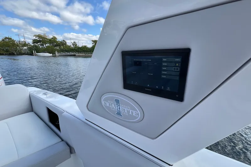 Slide: The Image of 2025 Cigarette 41 Nighthawk boat with touchscreen display, docked on a sunny day. - 41