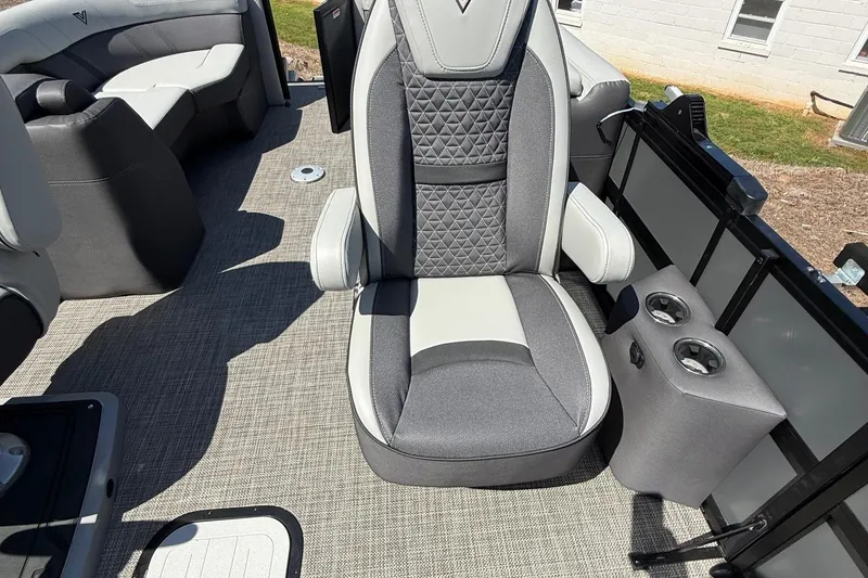 Slide: The Image of 2026 Viaggio Lago Z22U boat interior with gray and white seating, cup holders, and carpeted flooring. - 26