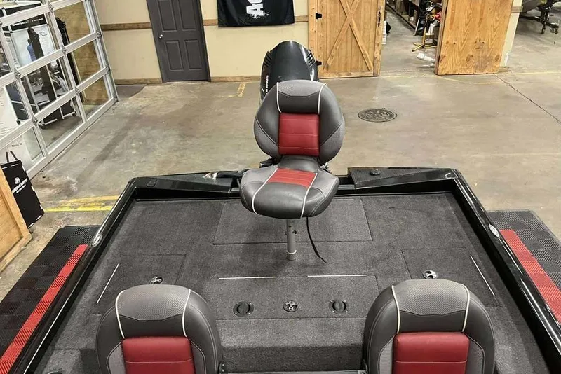 Slide: The Image of 2018 Ranger RT198P boat interior with red and gray seating in a garage setting. - 6
