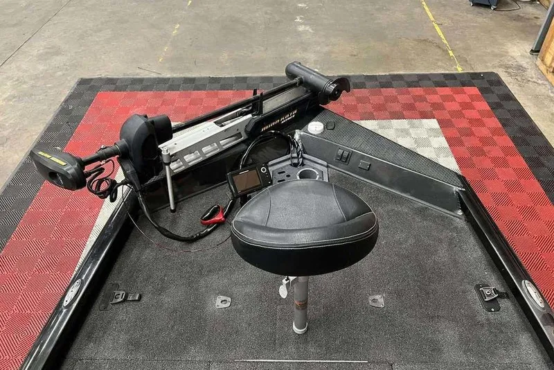 Slide: The Image of 2018 Ranger RT198P boat deck with trolling motor and seat on checkered mat. - 7