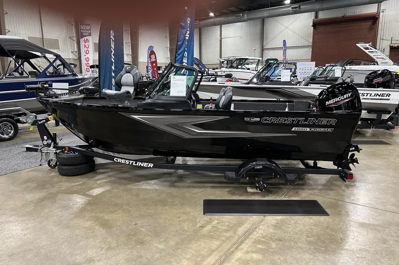 The Image of 2026 Crestliner 1650 Kodiak boat displayed indoors on a trailer. - 0