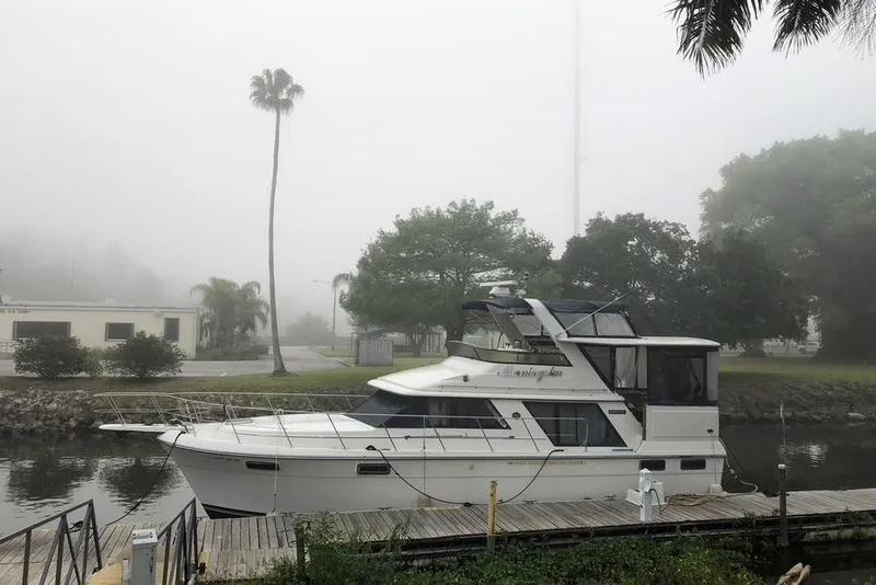 Slide: The Image of 1986 Carver 42 Aft Cabin Motoryacht docked on a foggy day. - 1