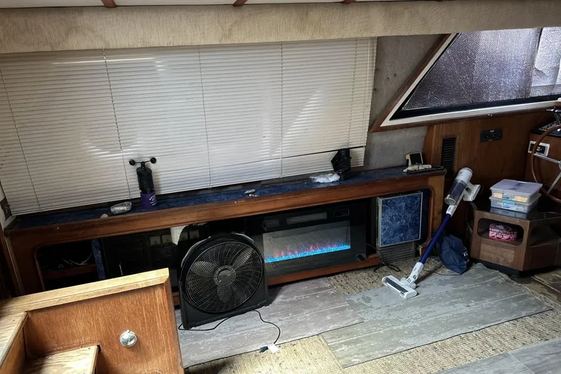 Slide: The Image of Interior of 1986 Carver 42 Aft Cabin Motoryacht with fan, vacuum, and electric fireplace. - 10