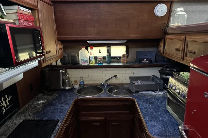 Slide: The Image of 1986 Carver 42 Aft Cabin Motoryacht kitchen with appliances and wooden cabinetry. - 11