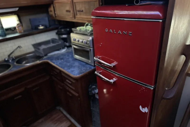 Slide: The Image of Red Galanz fridge in 1986 Carver 42 Aft Cabin Motoryacht kitchen with wooden cabinets. - 14