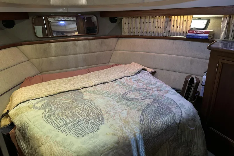 Slide: The Image of Cozy bedroom in 1986 Carver 42 Aft Cabin Motoryacht with patterned bedding and books. - 15