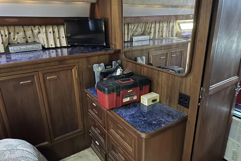 Slide: The Image of 1986 Carver 42 Aft Cabin Motoryacht interior with wood cabinetry and tool storage. - 16