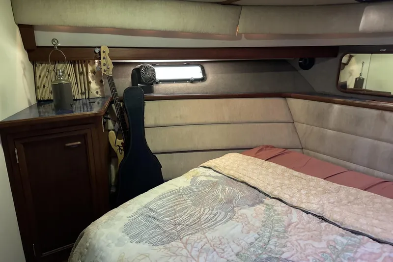 Slide: The Image of Cozy cabin interior of 1986 Carver 42 Aft Cabin Motoryacht with guitar and bedding. - 17