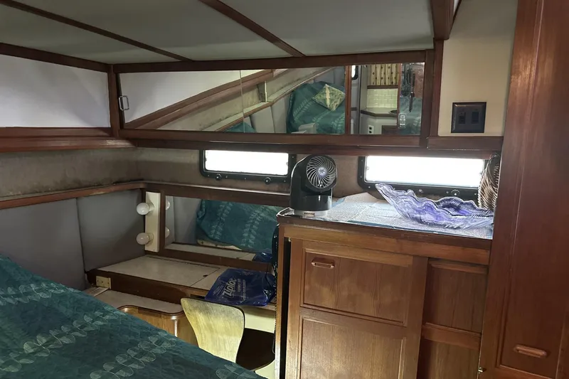 Slide: The Image of 1986 Carver 42 Aft Cabin Motoryacht interior with wood cabinetry and cozy sleeping area. - 19