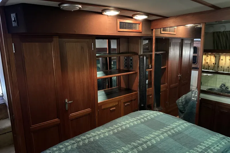Slide: The Image of 1986 Carver 42 Aft Cabin Motoryacht interior with wood cabinetry and cozy bedroom. - 20