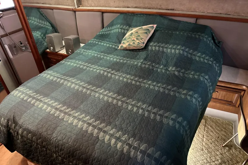 Slide: The Image of Cozy bedroom in 1986 Carver 42 Aft Cabin Motoryacht with patterned bedding. - 21