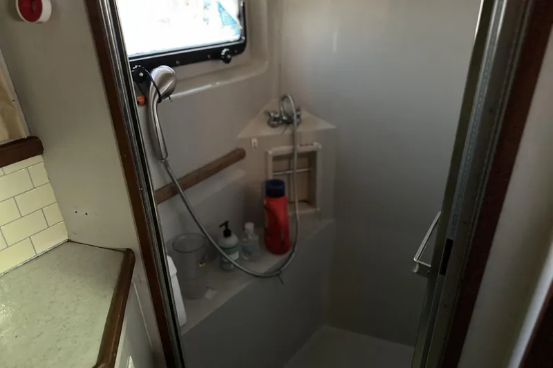 Slide: The Image of Shower area in 1986 Carver 42 Aft Cabin Motoryacht with handheld showerhead and toiletries. - 26