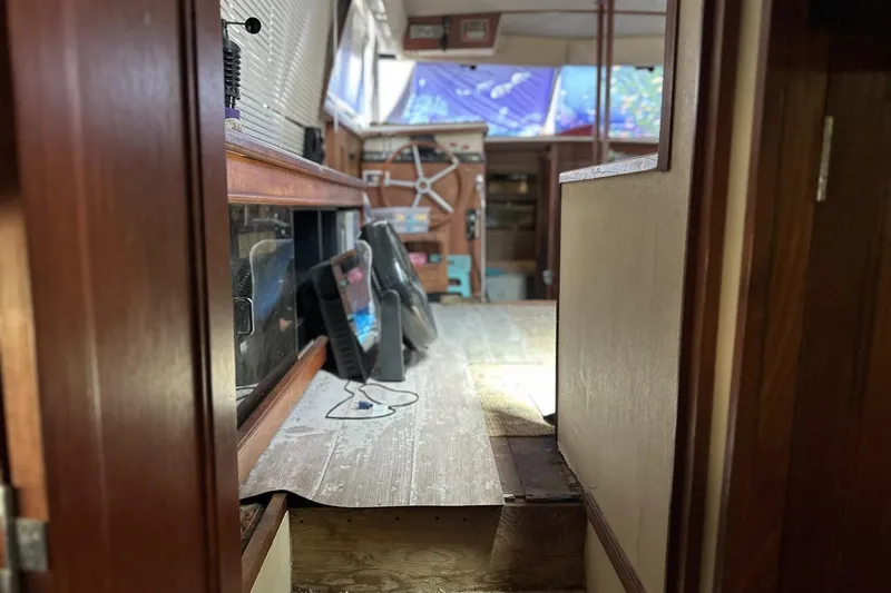 Slide: The Image of Interior view of 1986 Carver 42 Aft Cabin Motoryacht, featuring helm and wooden finishes. - 27