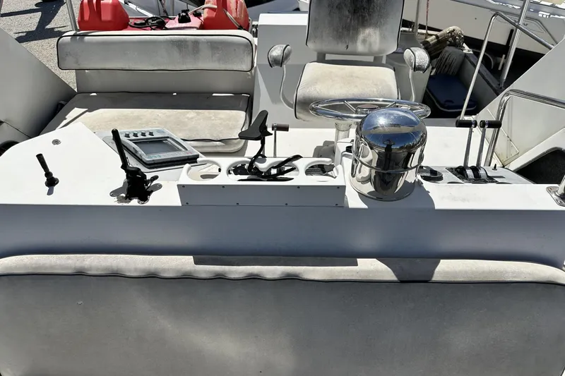 Slide: The Image of 1986 Carver 42 Aft Cabin Motoryacht helm with steering wheel and controls. - 34