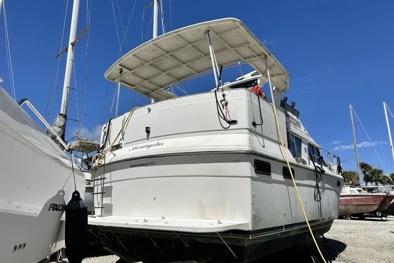 Slide: The Image of 1986 Carver 42 Aft Cabin Motoryacht docked under clear blue sky. - 36