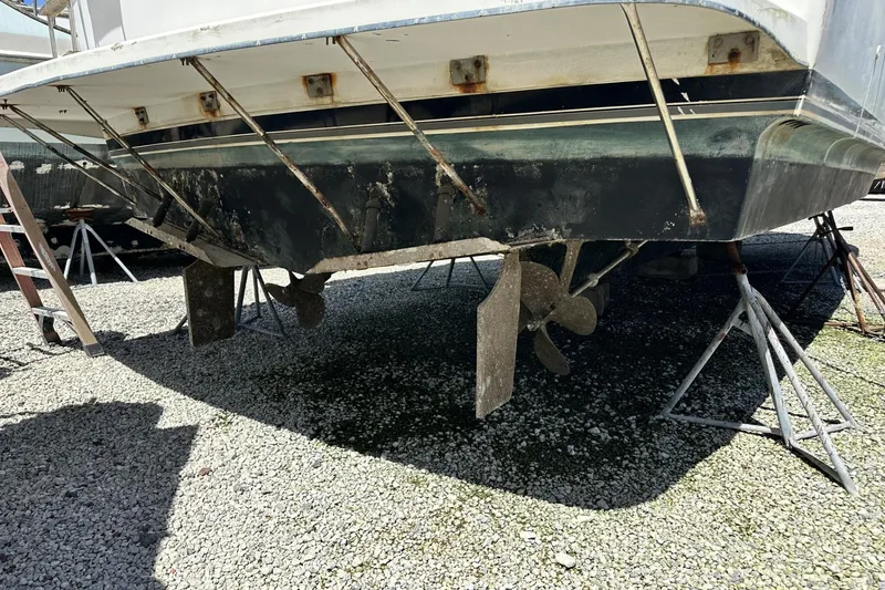 Slide: The Image of 1986 Carver 42 Aft Cabin Motoryacht on stands, showing propellers and hull condition. - 37