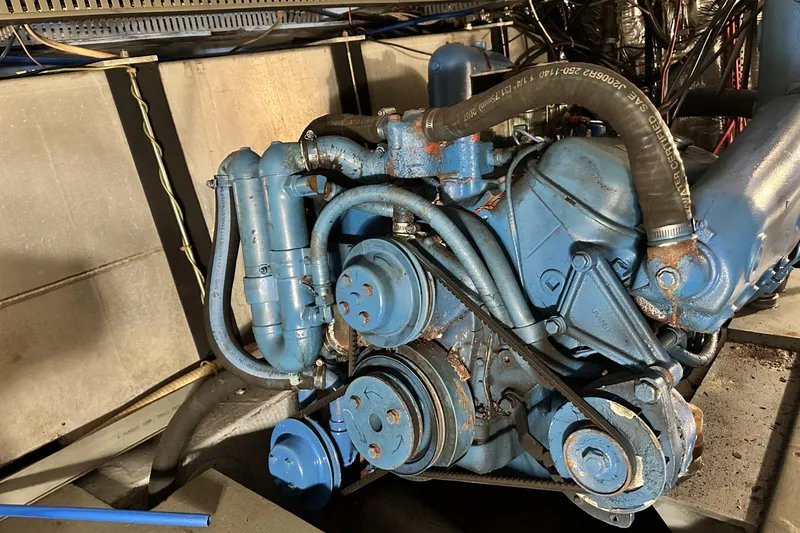 Slide: The Image of Engine of 1986 Carver 42 Aft Cabin Motoryacht, showing blue components and belts. - 39