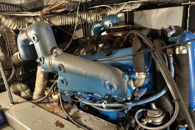 Slide: The Image of Engine compartment of a 1986 Carver 42 Aft Cabin Motor Yacht, showing blue machinery and hoses. - 40
