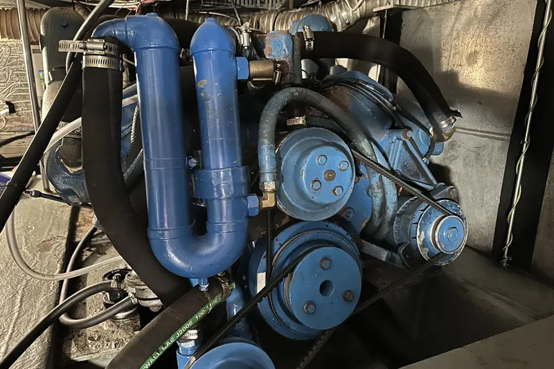 Slide: The Image of Engine of 1986 Carver 42 Aft Cabin Motoryacht, featuring blue components and hoses. - 41