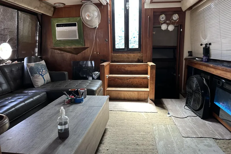 Slide: The Image of 1986 Carver 42 Aft Cabin Motoryacht interior with cozy seating and wooden accents. - 7