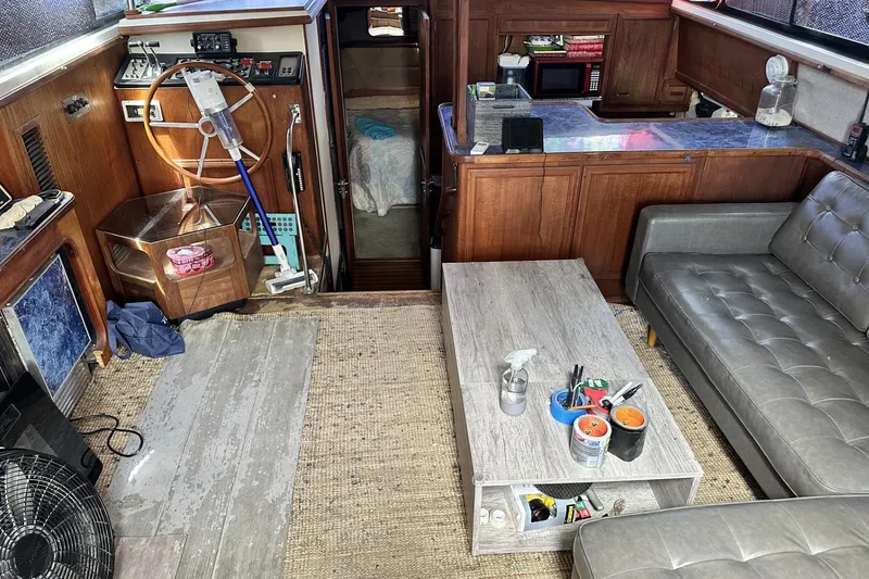 Slide: The Image of 1986 Carver 42 Aft Cabin Motoryacht interior with helm, sofa, and kitchenette. - 8