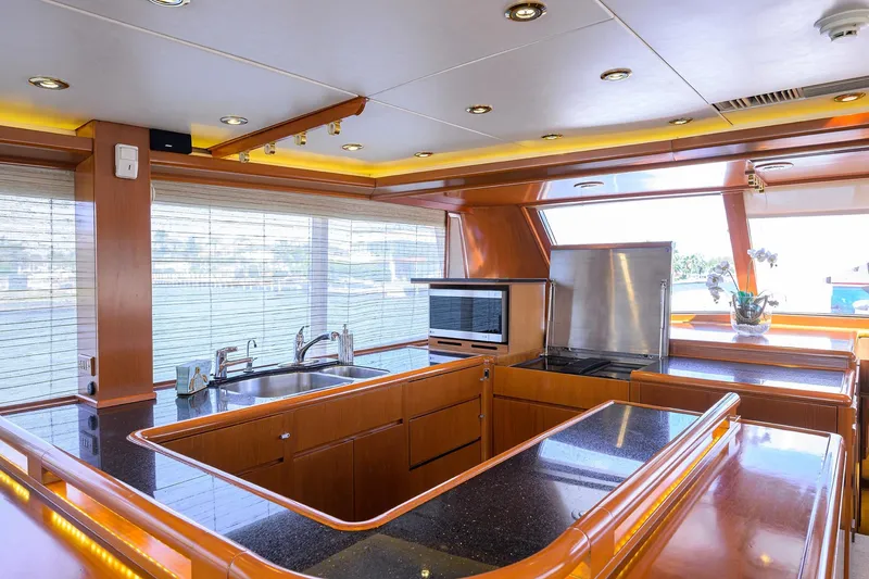 Slide: The Image of Luxurious kitchen interior of 1985 Feadship Yacht Fisherman with modern amenities and wood finishes. - 107