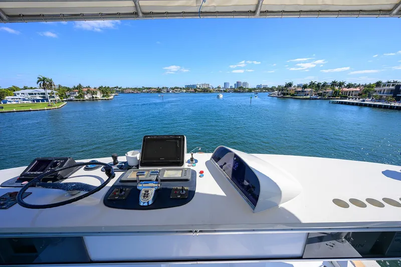 Slide: The Image of Helm view from 1985 Feadship Yacht Fisherman overlooking a scenic waterway. - 116