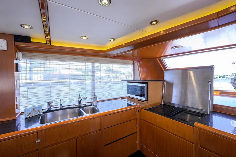 Slide: The Image of Luxurious kitchen interior of 1985 Feadship Yacht Fisherman with modern appliances and wood finish. - 119