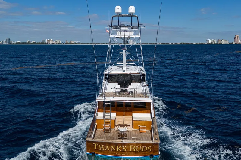 Slide: The Image of 1985 Feadship Yacht Fisherman cruising on open sea with city skyline in background. - 12