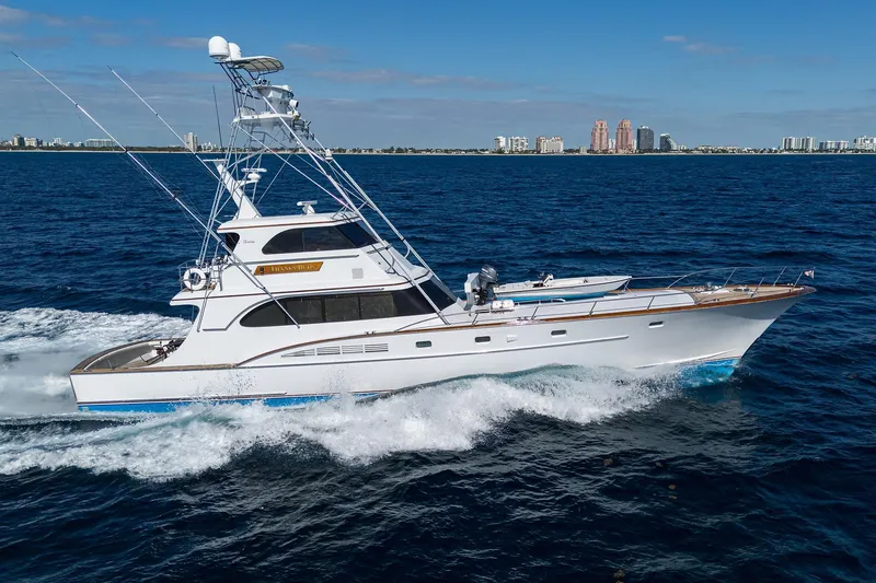 Slide: The Image of 1985 Feadship Yacht Fisherman cruising on open sea with city skyline in background. - 13
