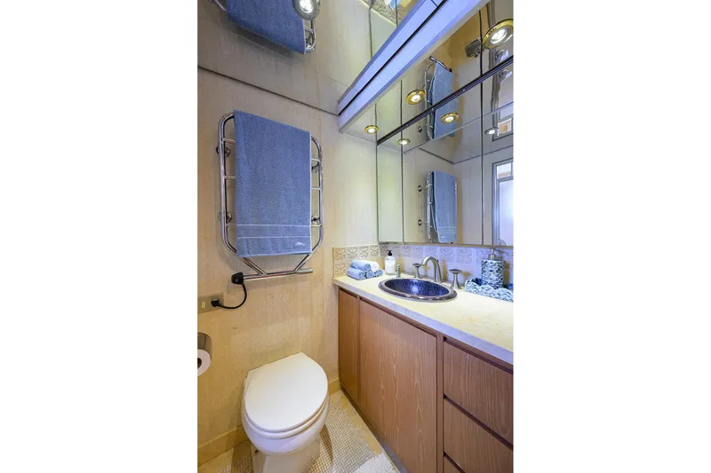Slide: The Image of Luxurious bathroom in 1985 Feadship Yacht Fisherman, featuring elegant fixtures and mirrored cabinetry. - 131