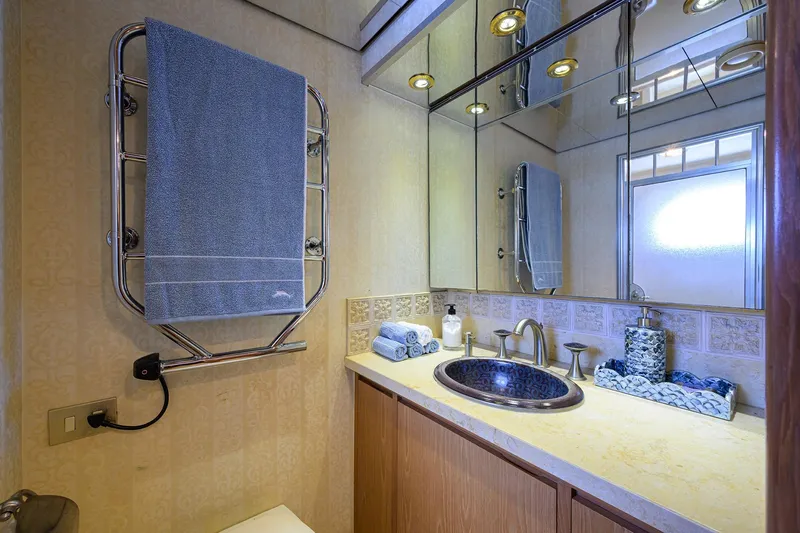 Slide: The Image of Luxurious bathroom on 1985 Feadship Yacht Fisherman with elegant fixtures and mirrored cabinets. - 132