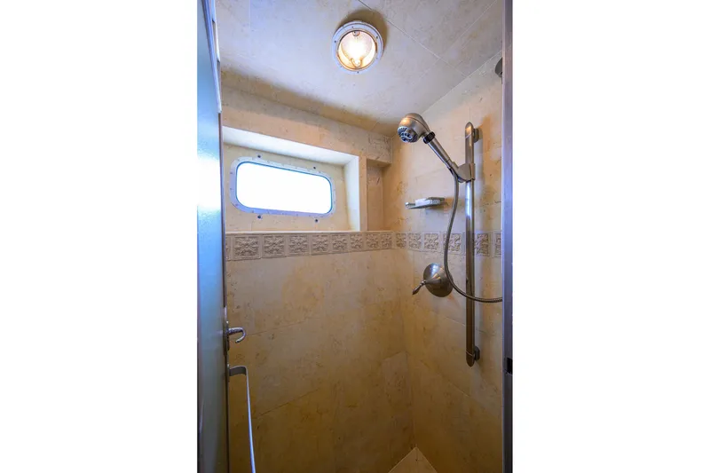 Slide: The Image of Shower area in 1985 Feadship Yacht Fisherman, featuring a window and modern fixtures. - 133