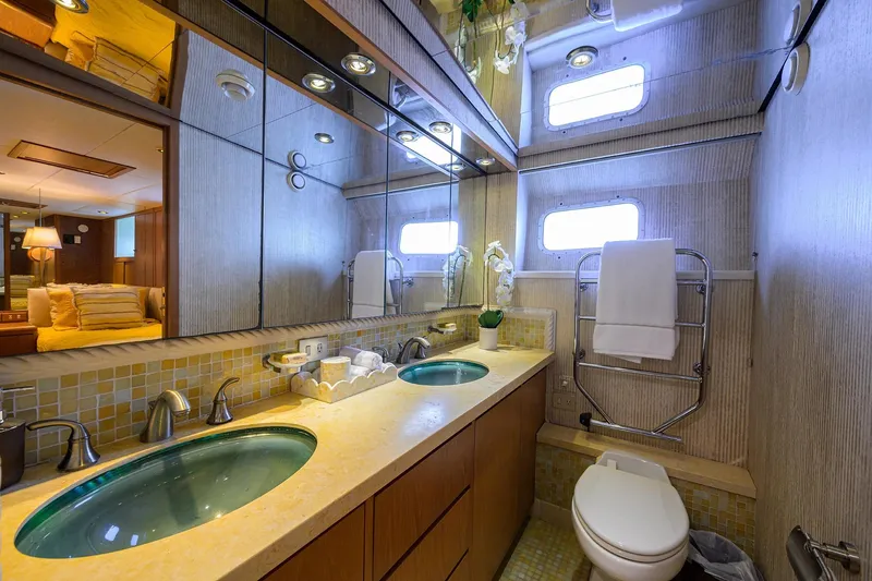 Slide: The Image of Luxurious bathroom in 1985 Feadship Yacht Fisherman, featuring elegant fixtures and mirrored walls. - 141