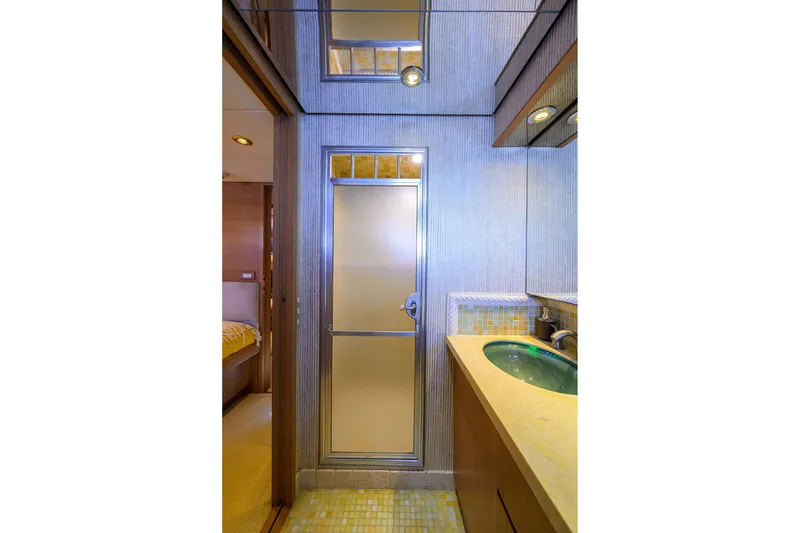 Slide: The Image of Bathroom interior of 1985 Feadship Yacht Fisherman, featuring modern fixtures and a sleek design. - 143
